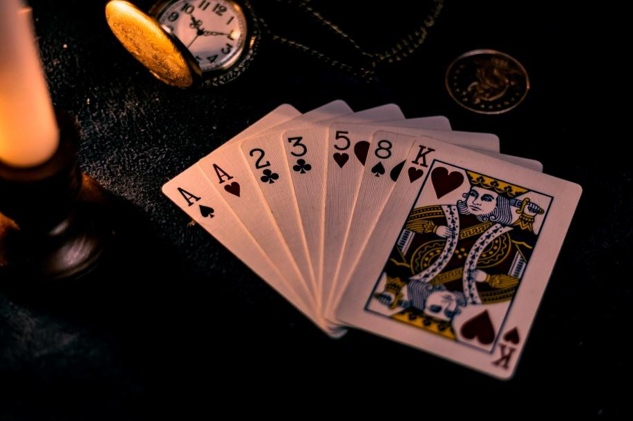 Close-up of playing cards arranged with warm lighting for luxury casino-themed décor at a private event.