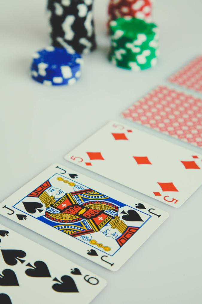 Poker cards and colorful chips arranged for a stylish casino-themed setup.