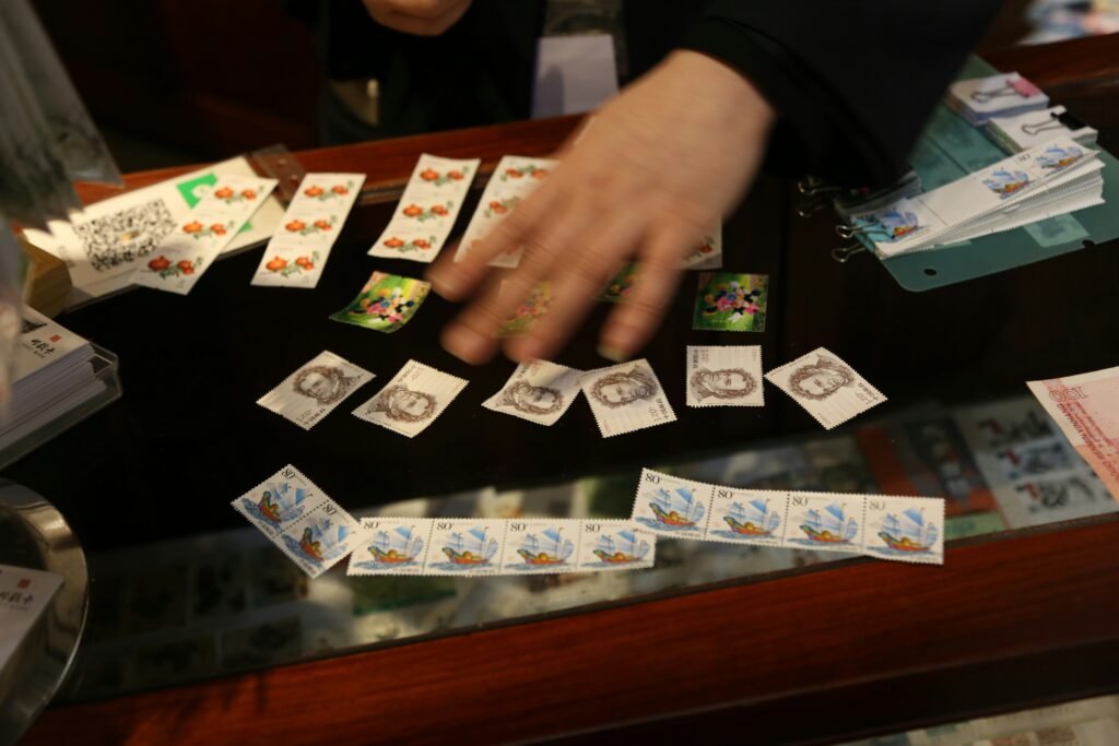 Dealer organizing game pieces and cards across a casino table during gameplay Caption: A dealer managing table elements in real time.