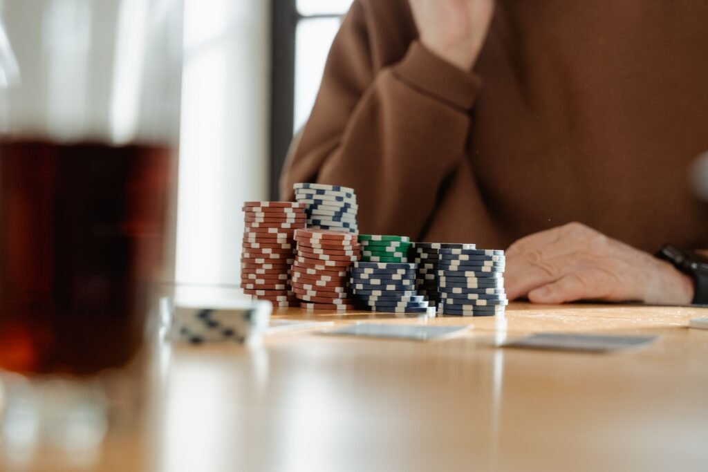 Stacks of poker chips arranged on a table during a casino-themed event with cards visible in the background