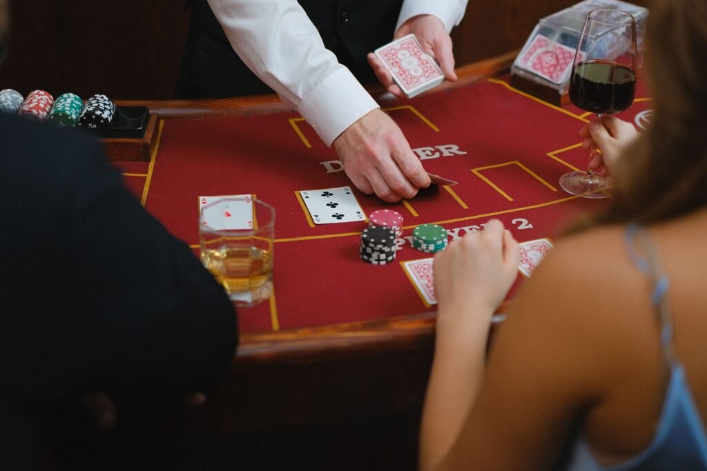 Guests participate in a blackjack game as a dealer manages the action during an upscale casino night experience.